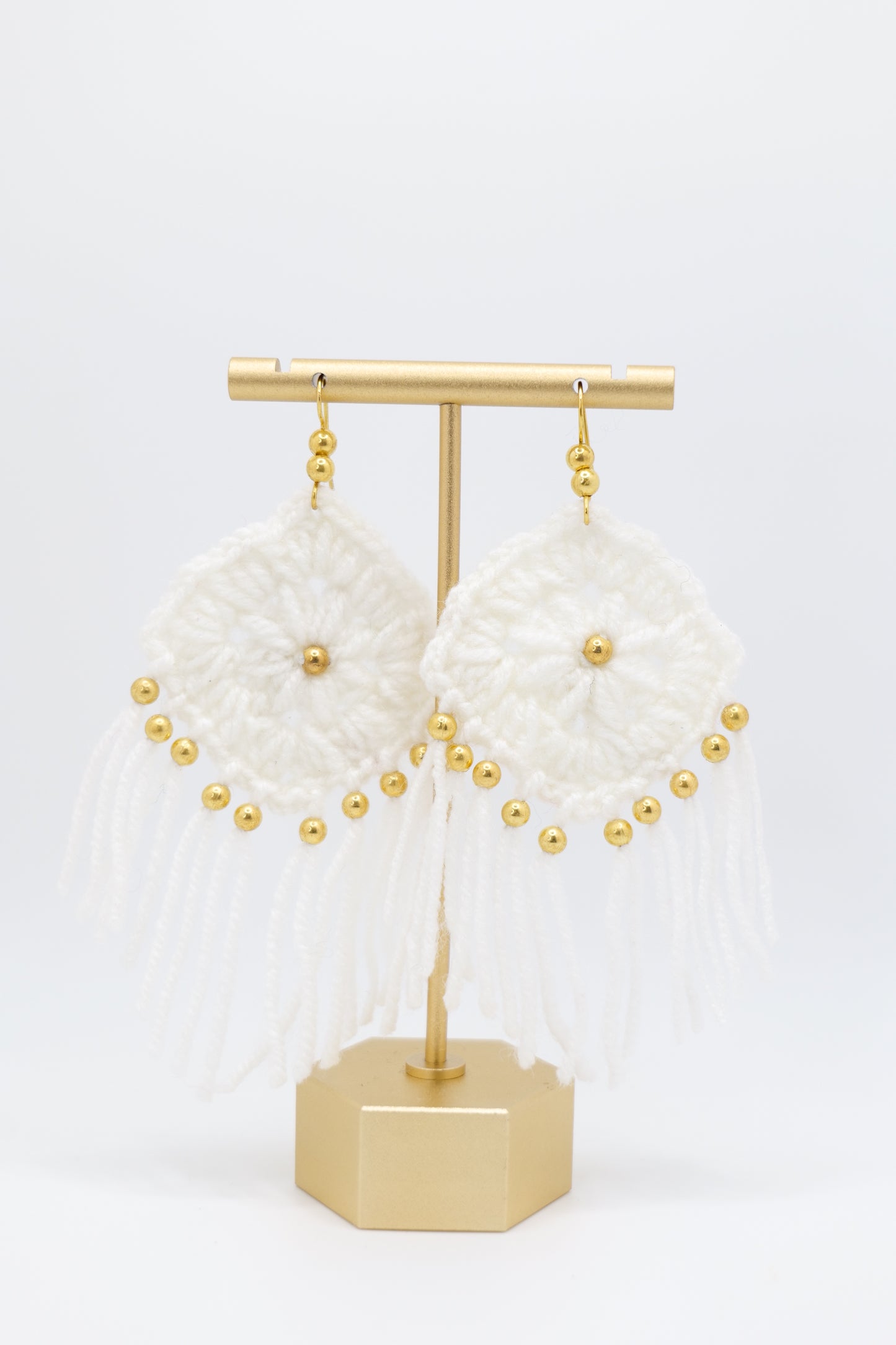 Crocheted tassel earrings with gold beads in white image 2