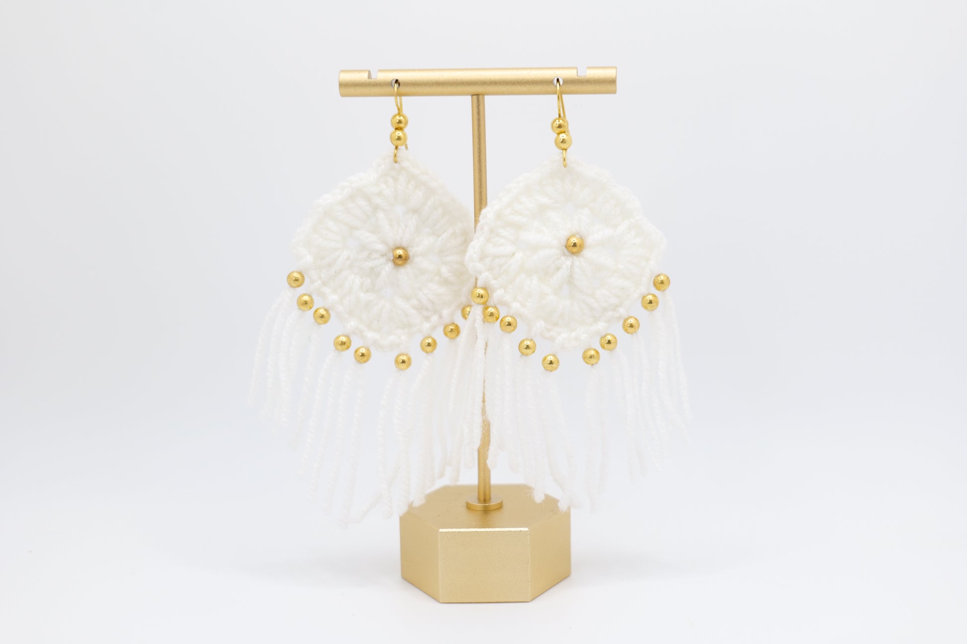 Crocheted tassel earrings with gold beads in white image 0